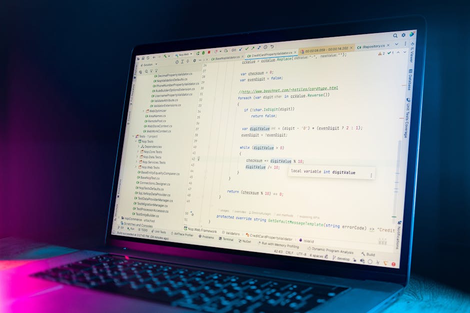 A close-up photograph of a computer screen displaying lines of colorful programming code, primarily in JavaScript, with text in shades of white, pink, blue, yellow, and green on a dark background. The